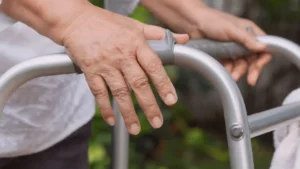 Elderly person walking with a walking stick