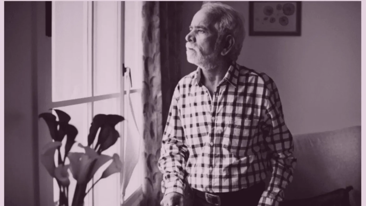 Elderly parent sitting at home showing signs of social withdrawal