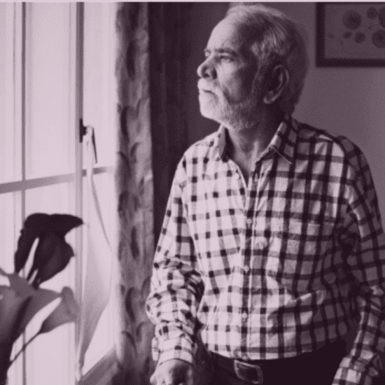 Elderly parent sitting at home showing signs of social withdrawal