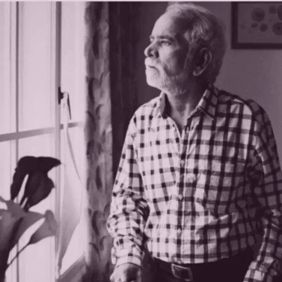 Elderly parent sitting at home showing signs of social withdrawal