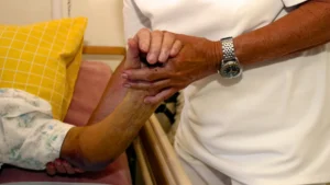 Elderly parent recovering at home in India after a heart attack with family support