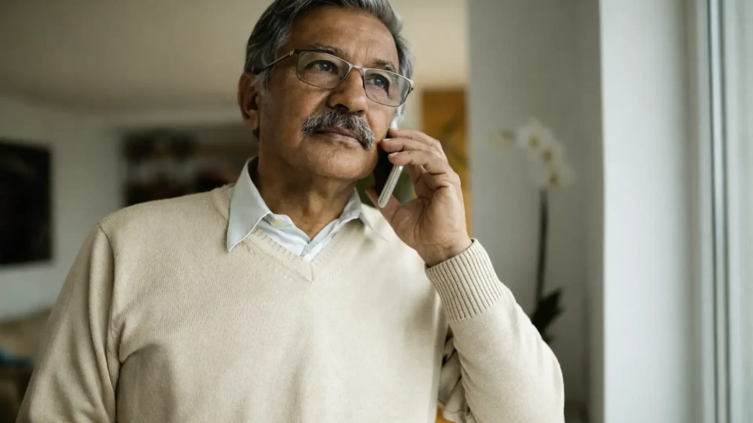 elderly parents on a video call with NRII children, looking concerned and emotional
