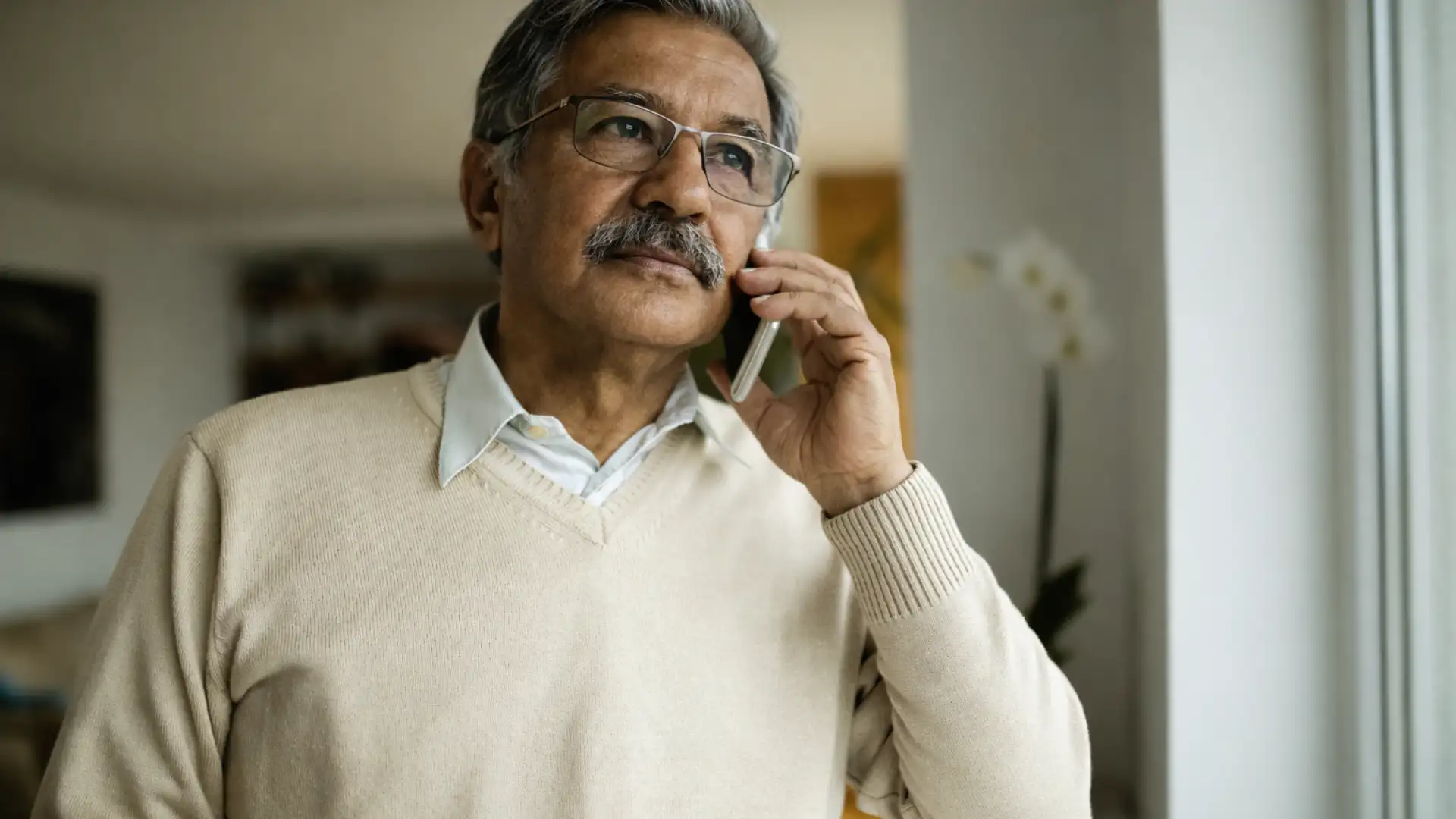 elderly parents on a video call with NRII children, looking concerned and emotional